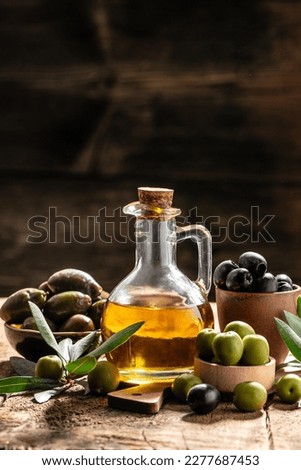 olives and oil. extra virgin olive oil jars on a wooden background. vertical image. place for text. Zdjęcia stock © 