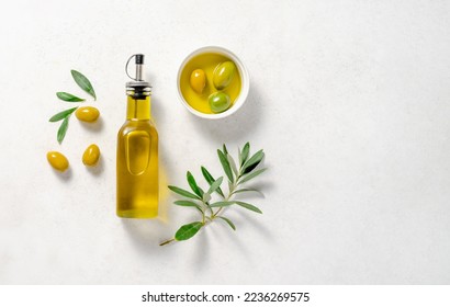 Olives and olive oil in white bowl with bottle of olive oil on white background. Mockup for package. Copy space. - Shutterstock ID 2236269575