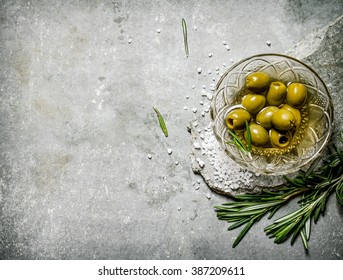 Olives with rosemary on a stone stand. On a stone background. - Powered by Shutterstock