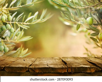 Olives with table. Wooden table with olive trees