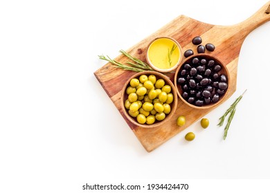 Olives in wooden bowl with oil and rosemary leaves, top view - Powered by Shutterstock