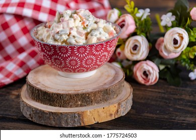 olivier salad in a bowl on wood