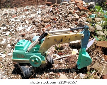 An Olld Excavator Breaking Down On The Rocks