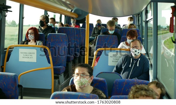 OLOMOUC, CZECH REPUBLIC, JUNE 22, 2020:
Coronavirus mask face bus crowd turning over people car passengers,
public transport prevention against risk covid-19 infection flu
virus safety outbreak