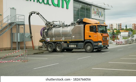 OLOMOUC, CZECH REPUBLIC, JUNE 29, 2020: Sewer Cleaning Tank Truck Car Pipe Drain Cleaning Shaft Septic Cesspool Pumping Suction Hose Under Pressure, Sump Contains Pollution Sludge Sewage Wastewater