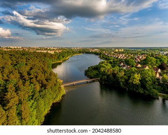 Olsztyn Lake Dlugie, bird's eye view. Wooded shores, the sky reflecting in the water table and a bridge over the lake - Warmia and Masuria, Poland - Shutterstock ID 2042488580