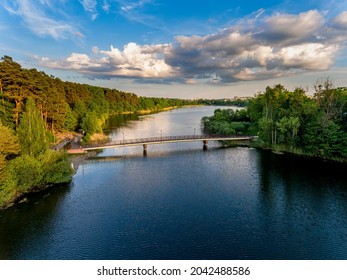 Olsztyn Lake Dlugie, bird's eye view. Wooded shores, the sky reflecting in the water table and a bridge over the lake - Warmia and Masuria, Poland - Shutterstock ID 2042488586