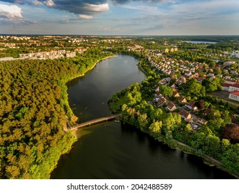 Olsztyn Lake Dlugie, bird's eye view. Wooded shores, the sky reflecting in the water table and a bridge over the lake - Warmia and Masuria, Poland - Shutterstock ID 2042488589