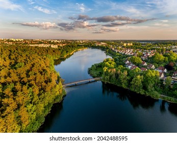 Olsztyn Lake Dlugie, bird's eye view. Wooded shores, the sky reflecting in the water table and a bridge over the lake - Warmia and Masuria, Poland - Shutterstock ID 2042488595