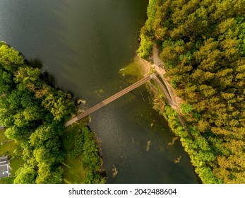 Olsztyn Lake Dlugie, bird's eye view. Wooded shores, the sky reflecting in the water table and a bridge over the lake - Warmia and Masuria, Poland - Shutterstock ID 2042488604