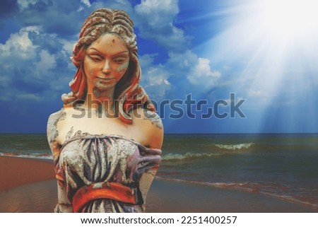 Olympic goddess of love and beauty in antique mythology Aphrodite (Venus) Fragment of ancient statue against sea landscape.. Copy space.
