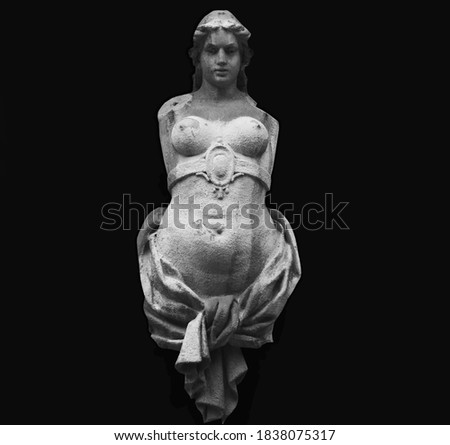 Olympic goddess of love and beauty Aphrodite (Venus) Fragment of ancient stone statue isolated on black background.