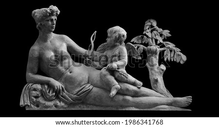 Olympic goddess of love and beauty Aphrodite (Venus) and little Cupid (Amur). An ancient statue. 