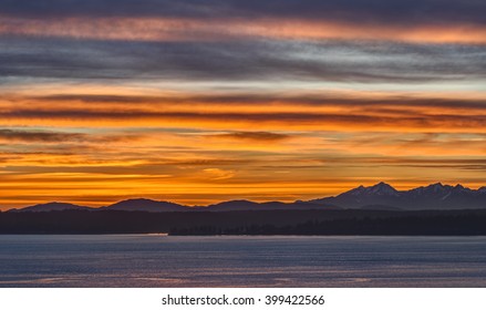 The Olympic Mountains are Bathed in a Sea of Orange and Red in this Sunset Image from Seattle, Washington