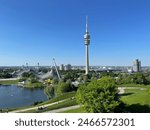 Olympic Park in Munich. At 291 m, the Olympic Tower is the tallest building in the city. Nowhere else can you get closer to the sky above Munich. BMW offices in the far right.