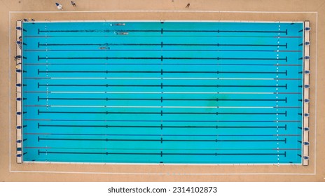 Olympic pool with three swimmers training
