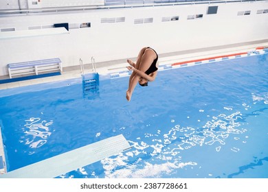 olympic sport, sports diving in the swimming pool, female athlete doing spin in the air - Powered by Shutterstock