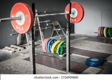 An Olympic Style Weightlifting Platform With Weights On A Bar.
