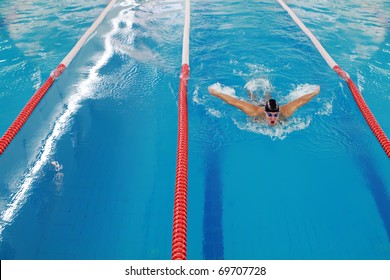 Olympic swimmer during butterfly stroke training in indoor swimming pool.  All the pictures in this series are of Vladan Markovic, Serbian butterfly champion and 4 times olympic swimmer: - Powered by Shutterstock