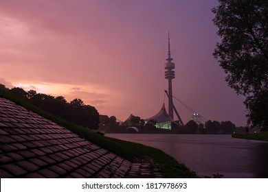 Olympic tower during sunset. Olympiaturm in Munich with the olympic lake in the foreground.