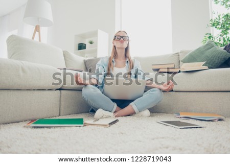 Om sign symbol gesture she her people person concept. Low angle close up view photo portrait of serious candid content pretty girl sitting on carper rug using holding netbook notebook on legs