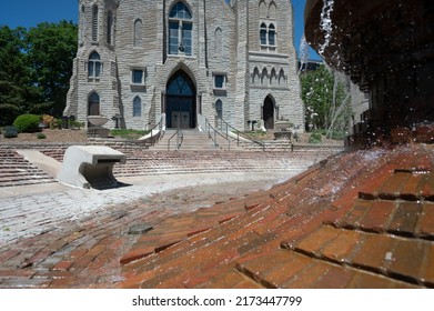 Omaha, Nebraska, US - 5.2022 - Selective Focus On Fountain In Front Of St. John's Parish Catholic Church On The Campus Of Creighton University.