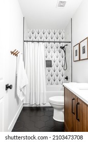 Omaha, Nebraska USA - 01-09-2022 Transitional Interior Design Styled Bathroom With Black Tile, Walnut Vanity, Black Faucets, Alabaster Paint