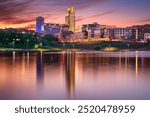 Omaha, Nebraska, USA. Cityscape image of downtown Omaha, Nebraska with reflection of the skyline at beautiful autumn sunset.