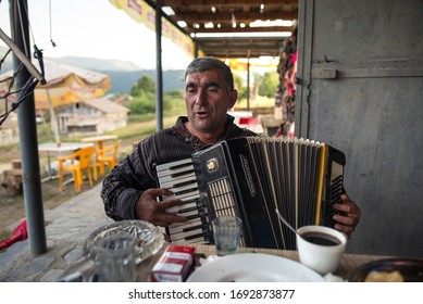 Omalo / Georgia - June 18, 2019: Portrait Of Adult Man Playing Accordion In A Restaurant In Omalo Village, Caucausus Mountains