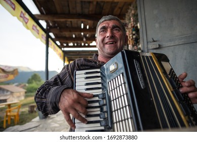 Omalo / Georgia - June 18, 2019: Portrait Of Adult Man Playing Accordion In A Restaurant In Omalo Village, Caucausus Mountains