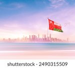 Oman national flag waving with scenic view of modern skyline. Oman independence day waving flag in beautiful skyline.