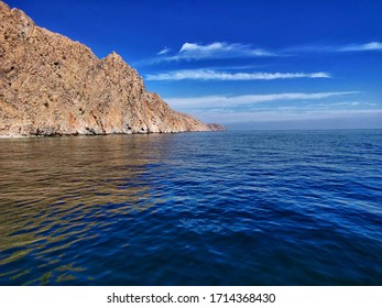 Oman, Sea View Of Limestone Hill,clear Sky,clear Water.