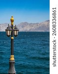 Oman: a street lamp facing the Strait of Hormuz on the seafront of one of the beaches along the Khasab Coastal Road in Musandam Peninsula (Ruus Al Jibal), the northeastern point of Arabian Peninsula