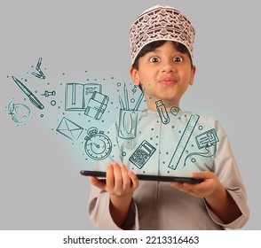 Omani boy using tablet device amazed with the technology - Powered by Shutterstock