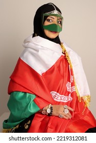 Omani Woman Wearing Traditional Clothes With Omani Flag  