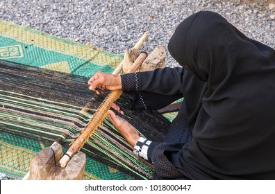 Omani Woman Weawing A Carpet