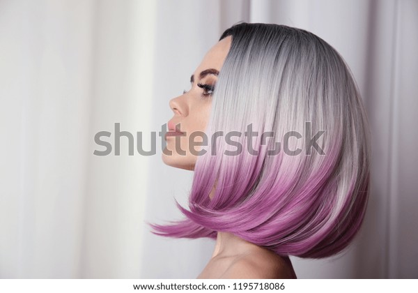 Ombre bob short hairstyle. Beautiful\
hair coloring woman. Trendy puprle haircut. Blond model with short\
shiny haircuts. Makeup. Beauty Salon\
Background.
