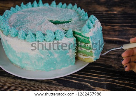 Ombre green cake for celebration on a dark wooden background