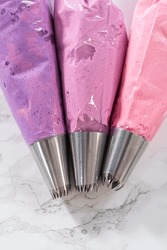 Ombre Pink Buttercream Frosting In A Piping Bag With A Jumbo Metal Piping Tip.