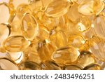 Omega 3 background from fish oil closeup. Vitamins soft capsules. Cod liver oil. Concept of healthcare, supplements, vitamin D, treatment of diseases. Copy space, banner. High quality photo