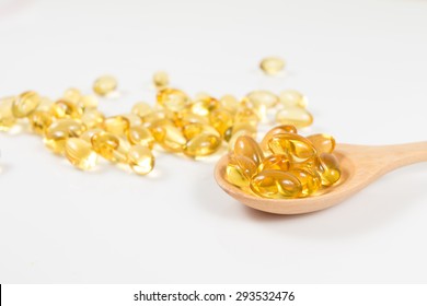 Omega 3 Fish Oil Capsules On Wooden Spoon.