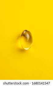 Omega 3 Pills. Fish Oil Supplement Capsules On Yellow Background. Top View.