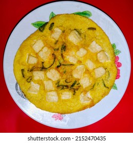 Omelet With Diced Tofu And Chopped Scallions On A White Plate