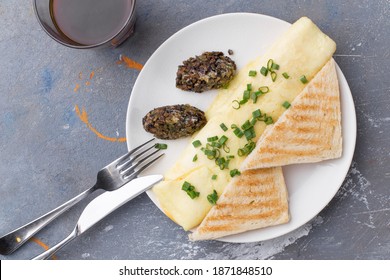 Omelette With Fried Champignon Mushrooms, Cheese And Toasted Bread And Cup Of Coffee On Gray Table Top View