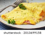 Omelette with ham and cheese on the plate