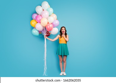 Omg Its For Me. Full Size Photo Astonished Girl Get Many Helium Baloons Woman Day Celebration Scream Touch Hands Face Wear Bright Short Mini Singlet Footwear Isolated Blue Color Background