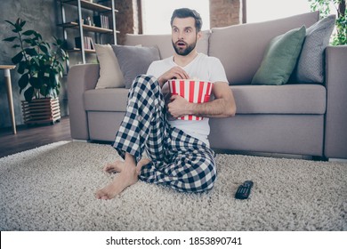 Omg What Is It. Astonished Man Have Quarantine Free Time Watch Movie Impressed Unexpected Thriller Ending Hold Big Red Striped Pop Corn Box Sit Carpet In House Indoors