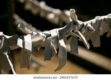 Omikuji or fortune paper at a Shinto shrine in the city of Sakura in Japan. - Powered by Shutterstock