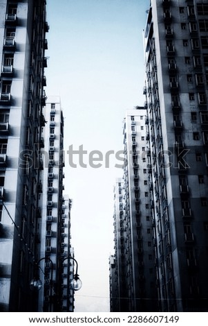 Ominous empty skyscrapers abandoned after apocalypse. Rows of tall apartment buildings in the evening 