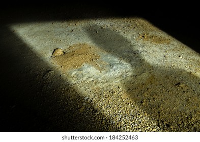Ominous Looking Shadow Of A Man Projected On The Ground In A Doorway